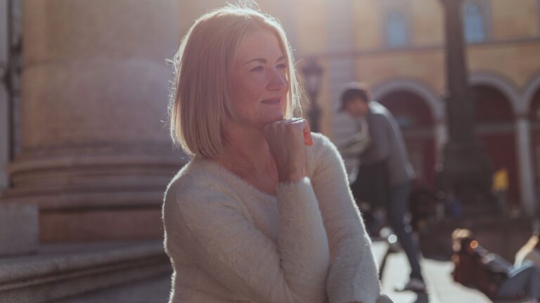 A middle-aged woman enjoying a sunny day outdoors in Munich, Germany.